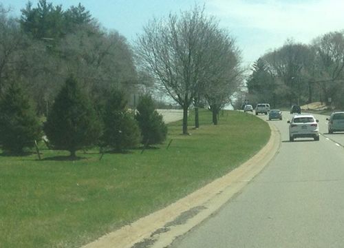 The image shows a multi-lane road with several cars driving on it