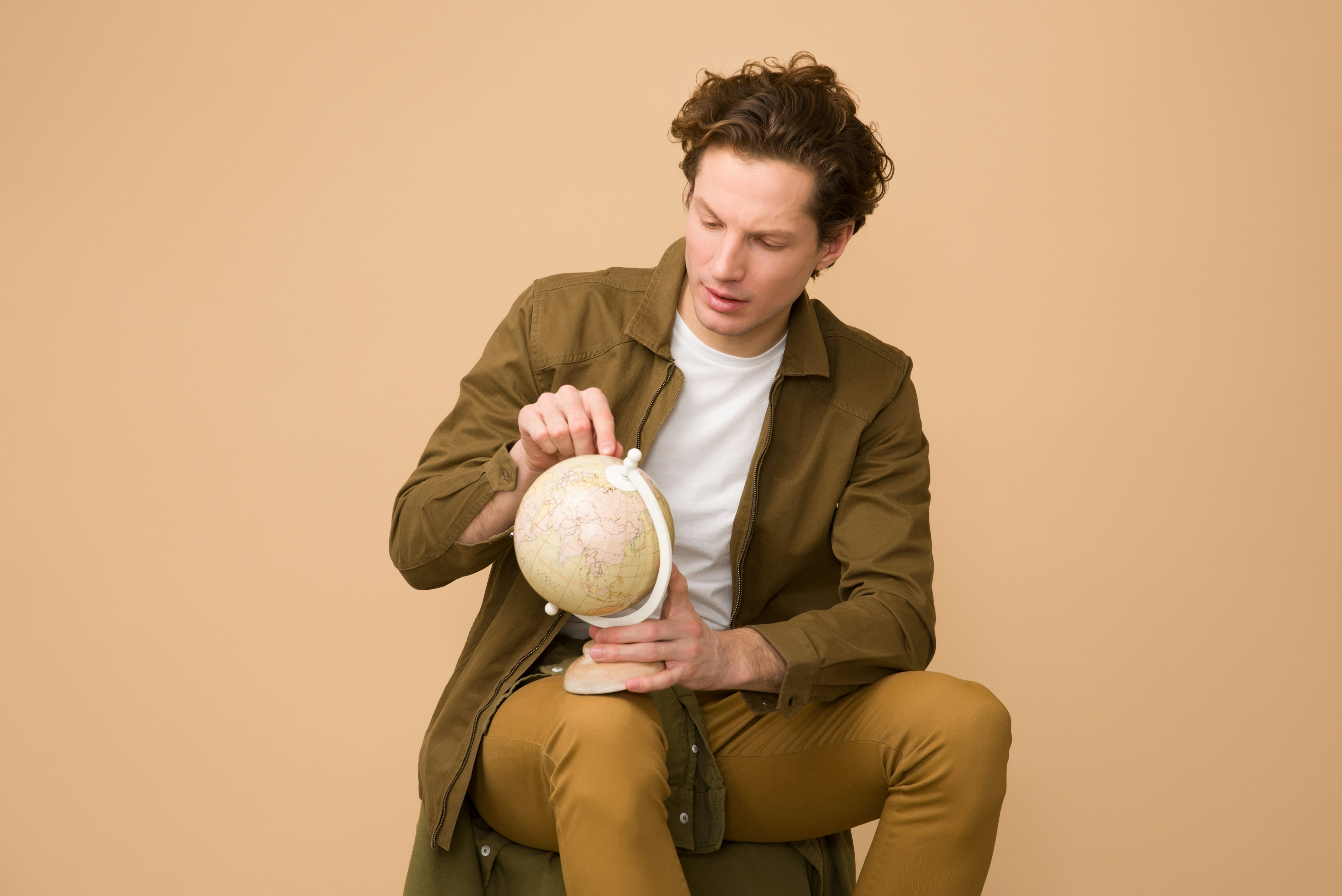 Man sitting and searching globe