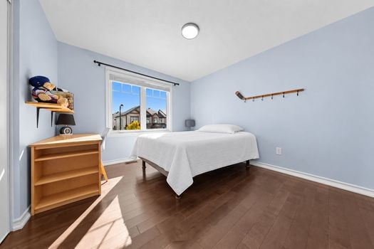 Bright Minimal Bedroom with Hockey Rack