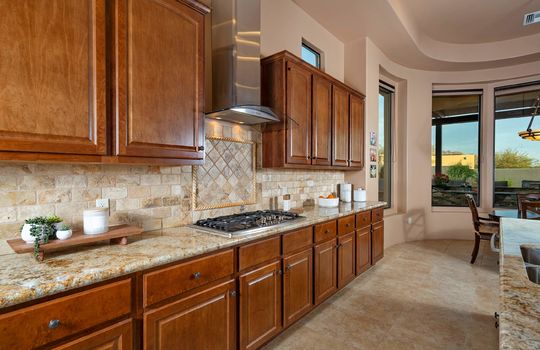 Gas Cooktop With Framed Tile Backsplash and Stylish Range Hood