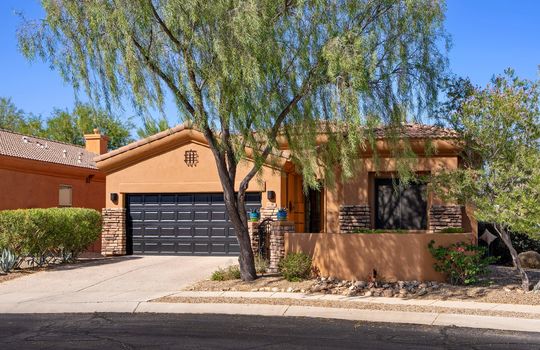 Charming exterior with mature trees and a courtyard