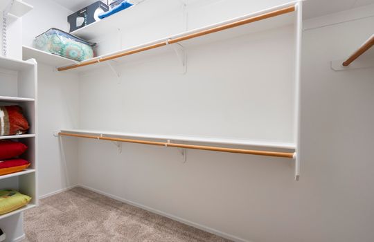 Large primary walk-in closet has a LOT of storage space