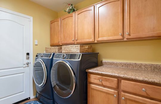 Laundry room has abundant storage and a folding counter (there is a utility sink in the garage)