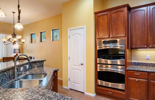 Open kitchen with plenty of workspace on the granite counters and a breakfast bar