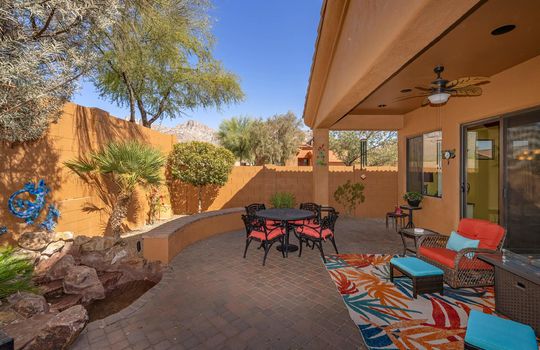 Outdoor space has an oversize paver patio with a relaxing water feature