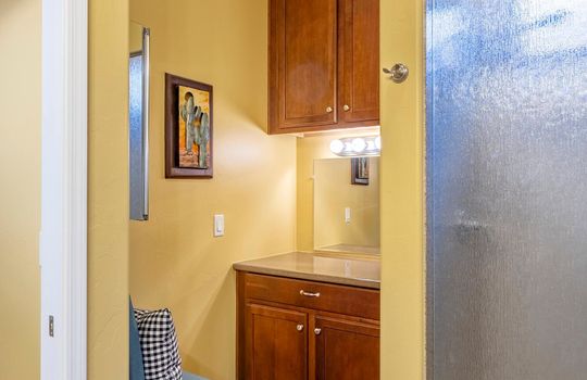 Primary bath also features a grooming station with extra lighting