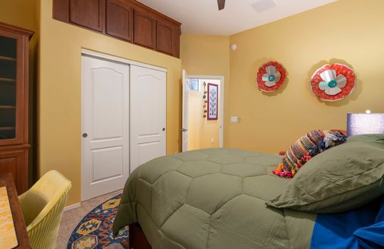 This bedroom also features built-in cabinet storage above the closet