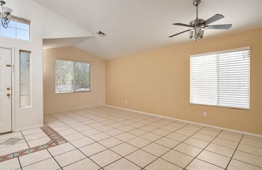 Large Living Space With Ceiling Fan And Vaulted Ceilings
