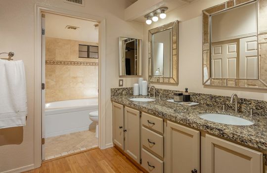 Primary Bathroom Features Dual Sinks and Granite Counter