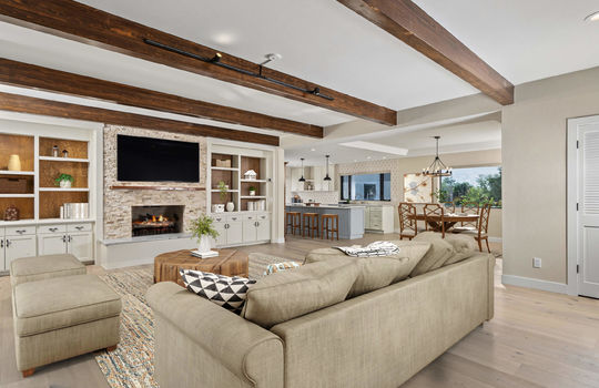Great Room With Beamed Ceilings and Gas Fireplace- Digitally Staged
