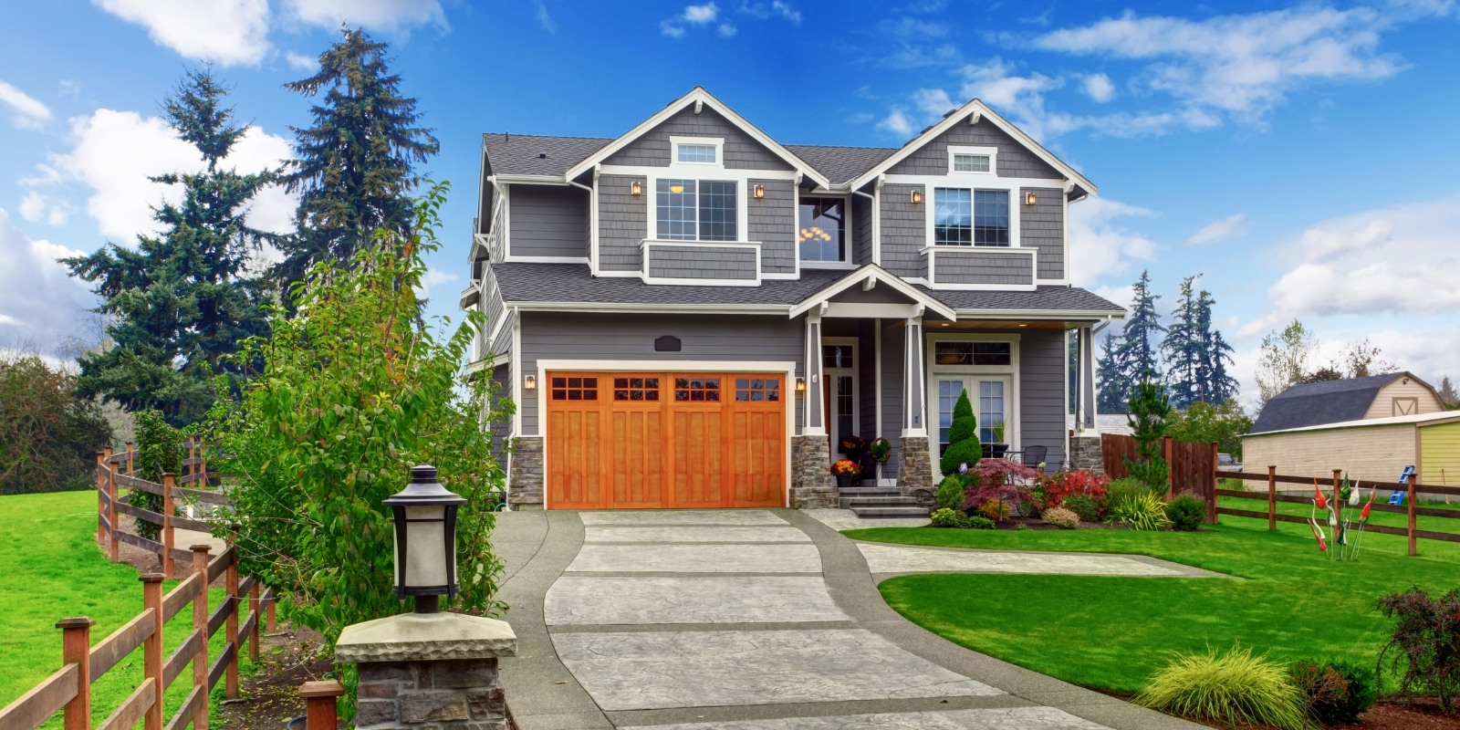 Grey house with tan garage and excellent curb appeal