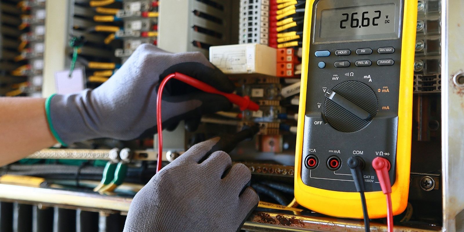 Electrician checking voltage reading in an electrical system