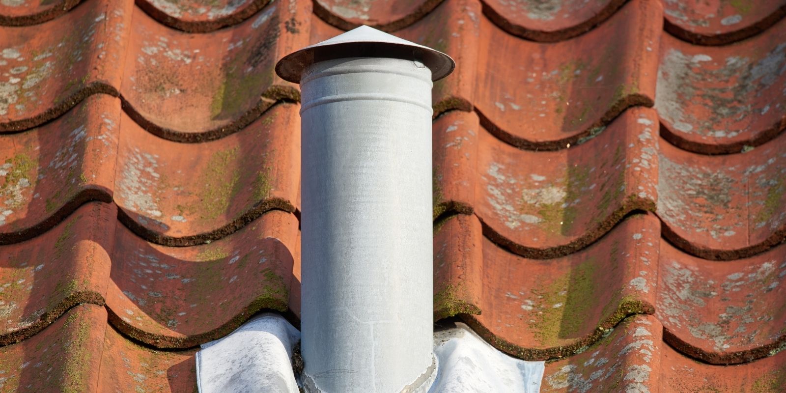 Old vent on a slate tile rooftop