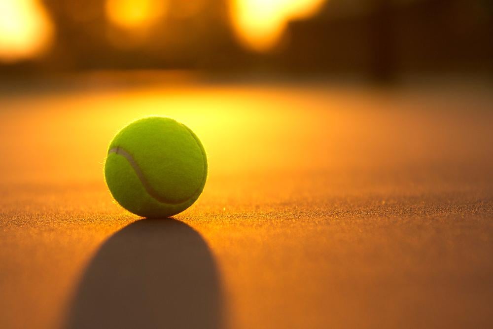 Tennis Ball on the Court as the Sun sets