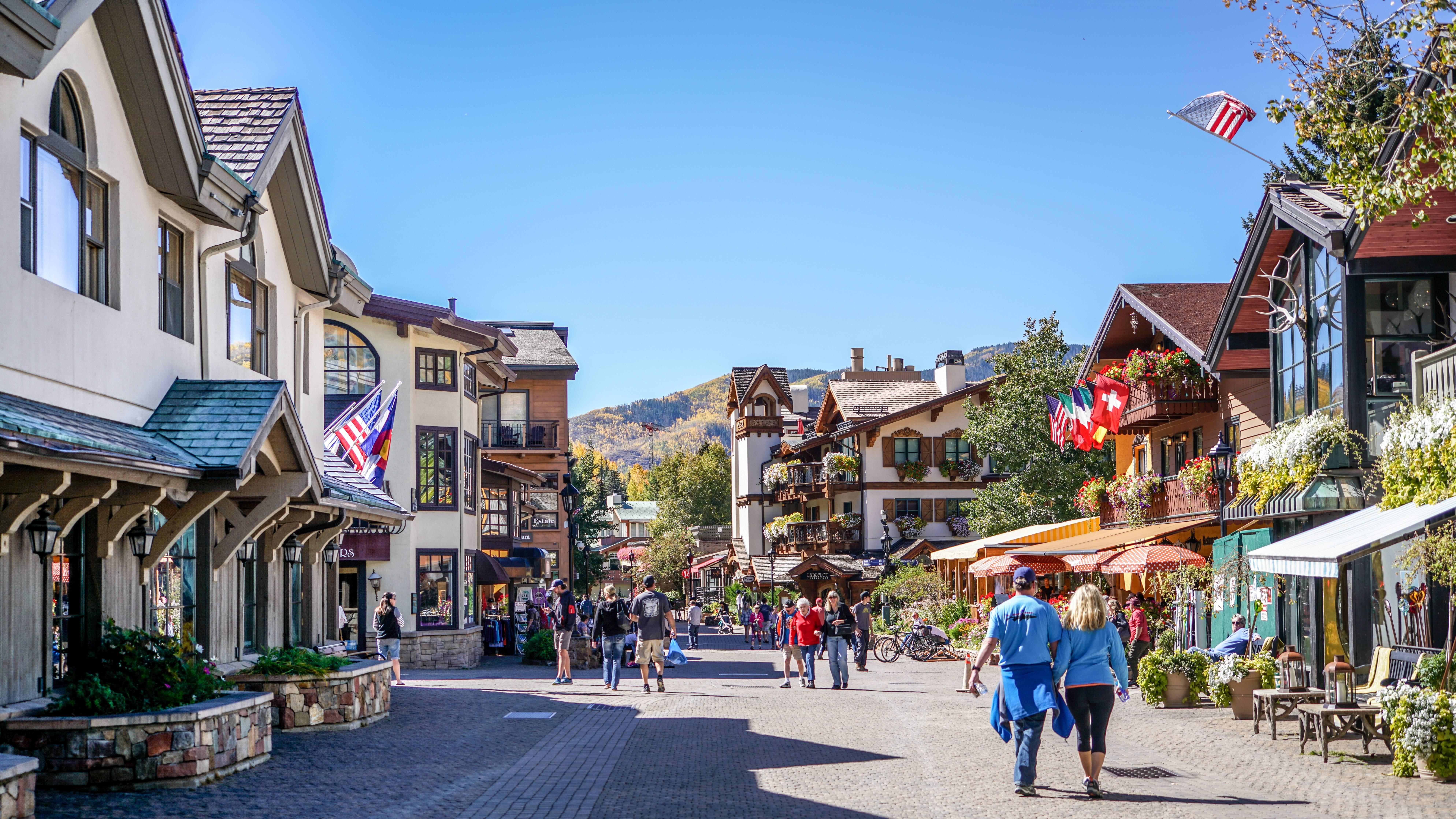 Vail Village in early fall, with aspens turning gold on the hillside above Bridge Street, Vail Colorado