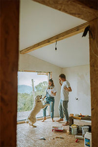 Home owners enjoying their newly renovated home with their dog.