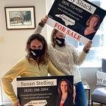 North Carolina Realtor's Susan Stelling and Emily Shack holding for sale signs at 828 Real Estate in Boone, NC.