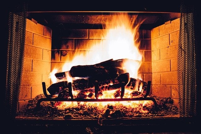 A fire burning inside a clean and winterized fireplace and chimney