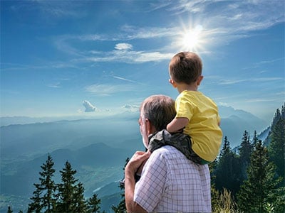 A father and son taking in the view from Grandfather Mountain on the Blue Ridge Parkway in Banner Elk, NC