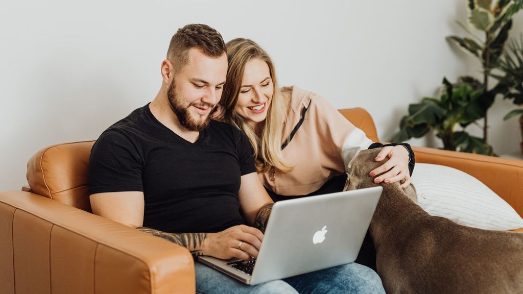 A couple watching a virtual tour of a home