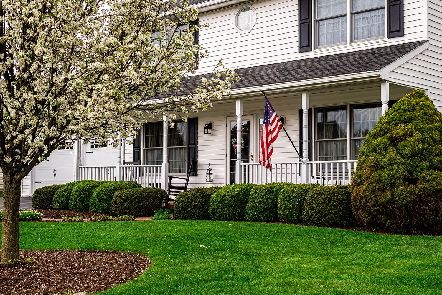 White,Colonial,House,With,American,Flag