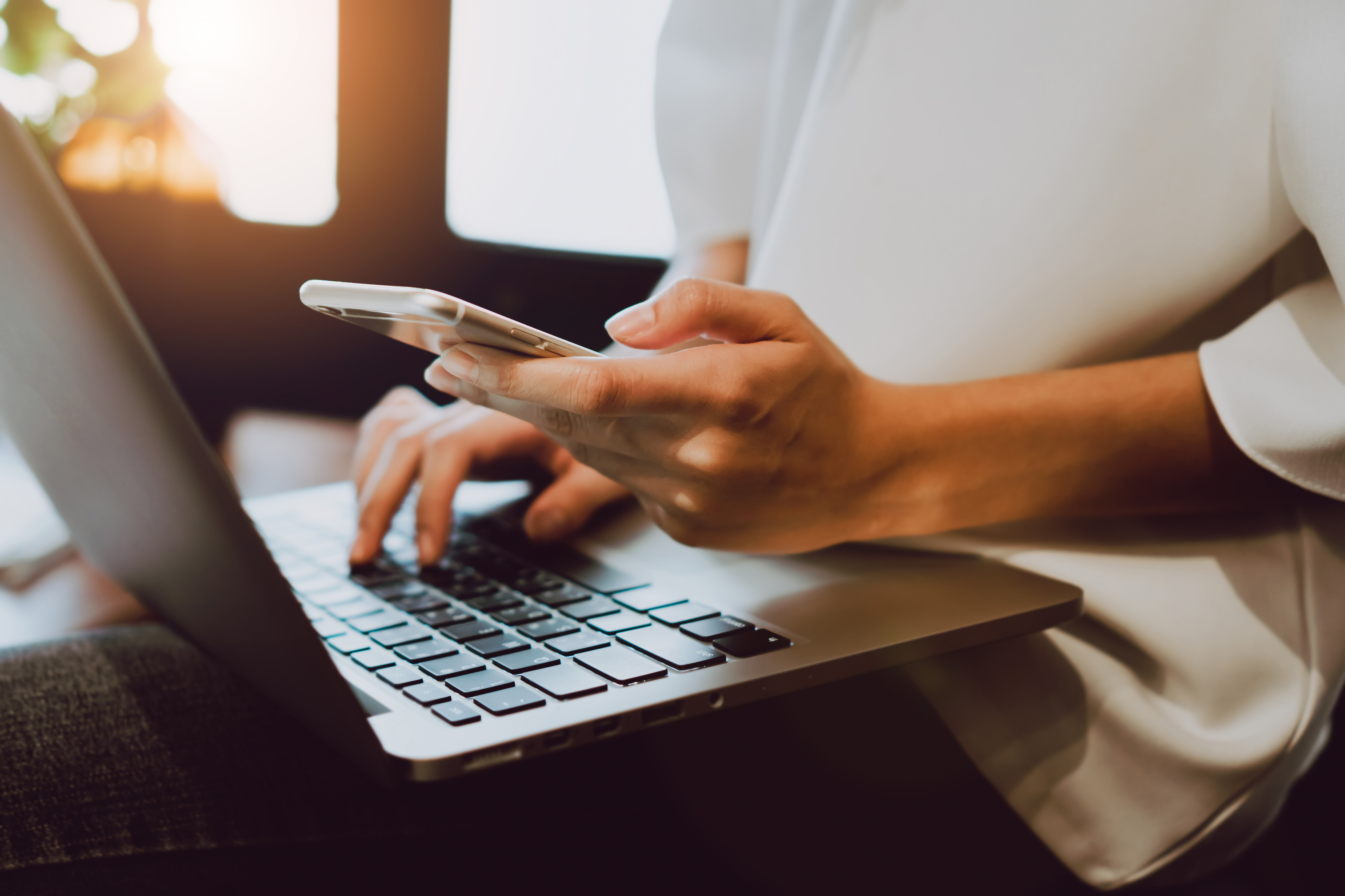 Soft focus of woman hand working with phone on desk in coffee sh