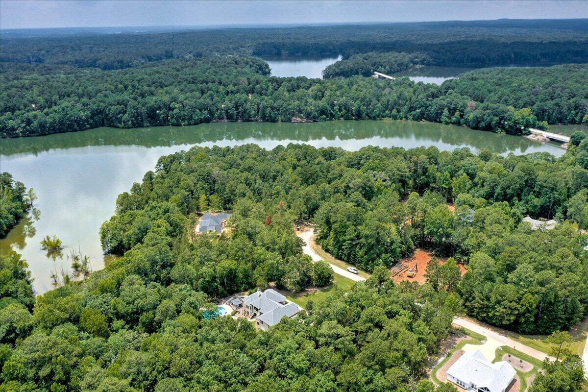Aerial view of neighborhoods in Savannah Lakes Village surrounded by forest and lake