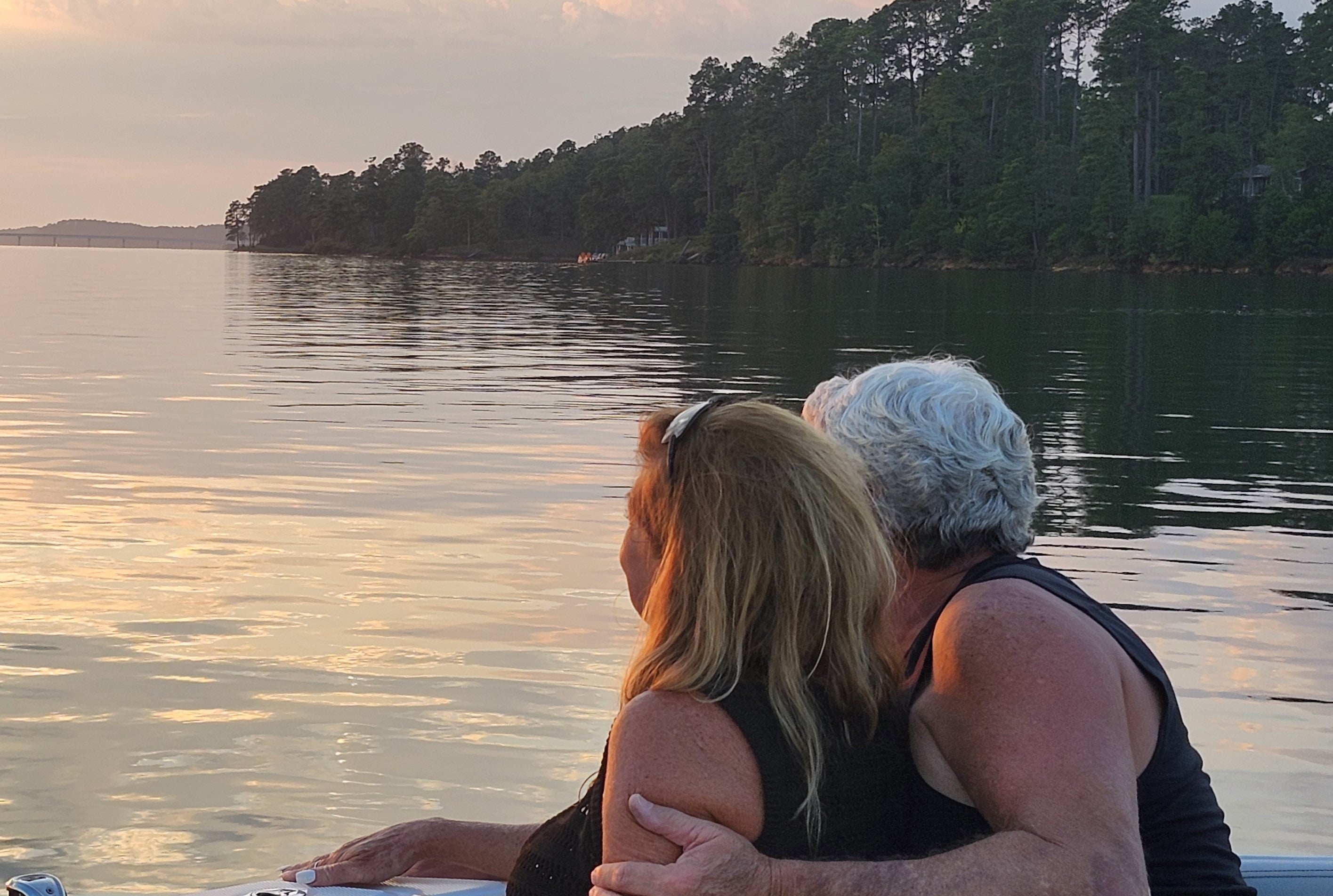 Couple resting on a boat at sunset at Savannah Lakes Village
