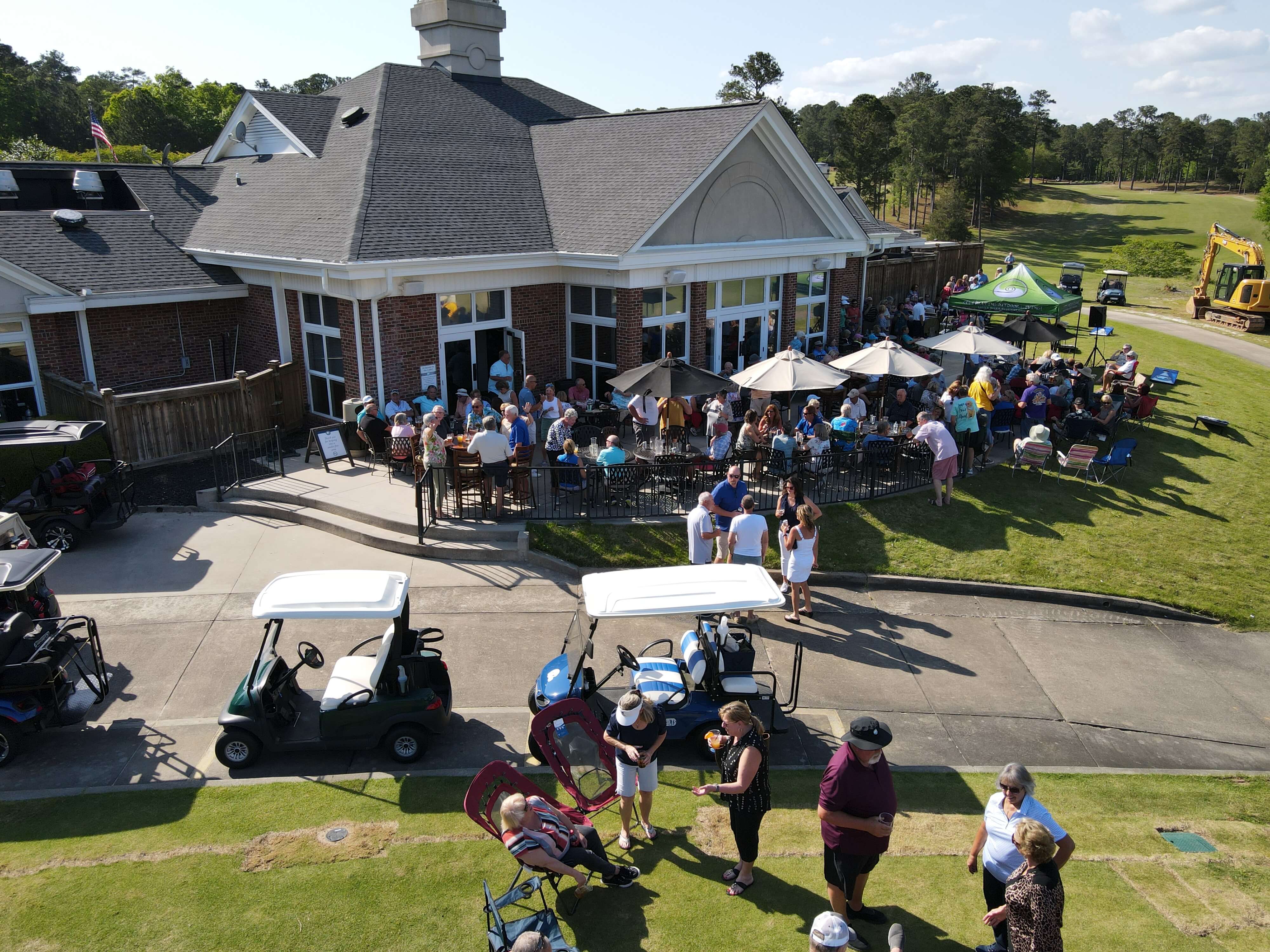 Neighbors gathering at the Tara Clubhouse patio in Savannah Lakes Village at sunset