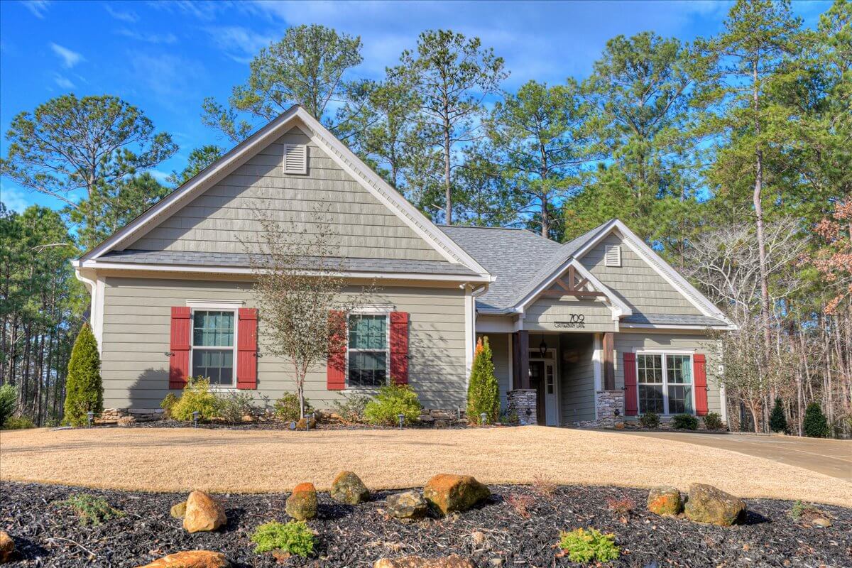 Couple touring a Savannah Lakes Village lake home with their agent on a cool winter day