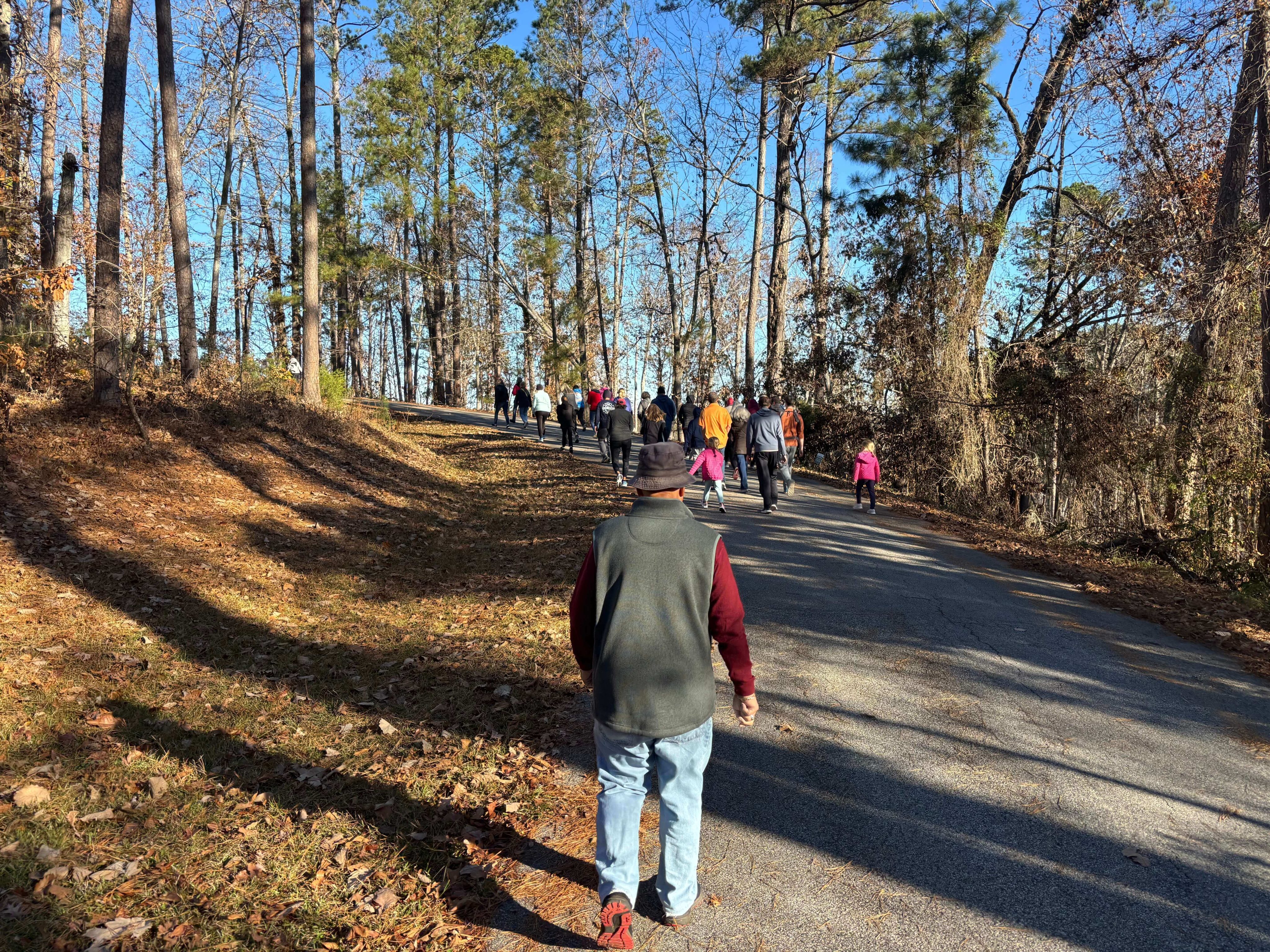 Active adult residents walking along a lakefront path in Savannah Lakes Village