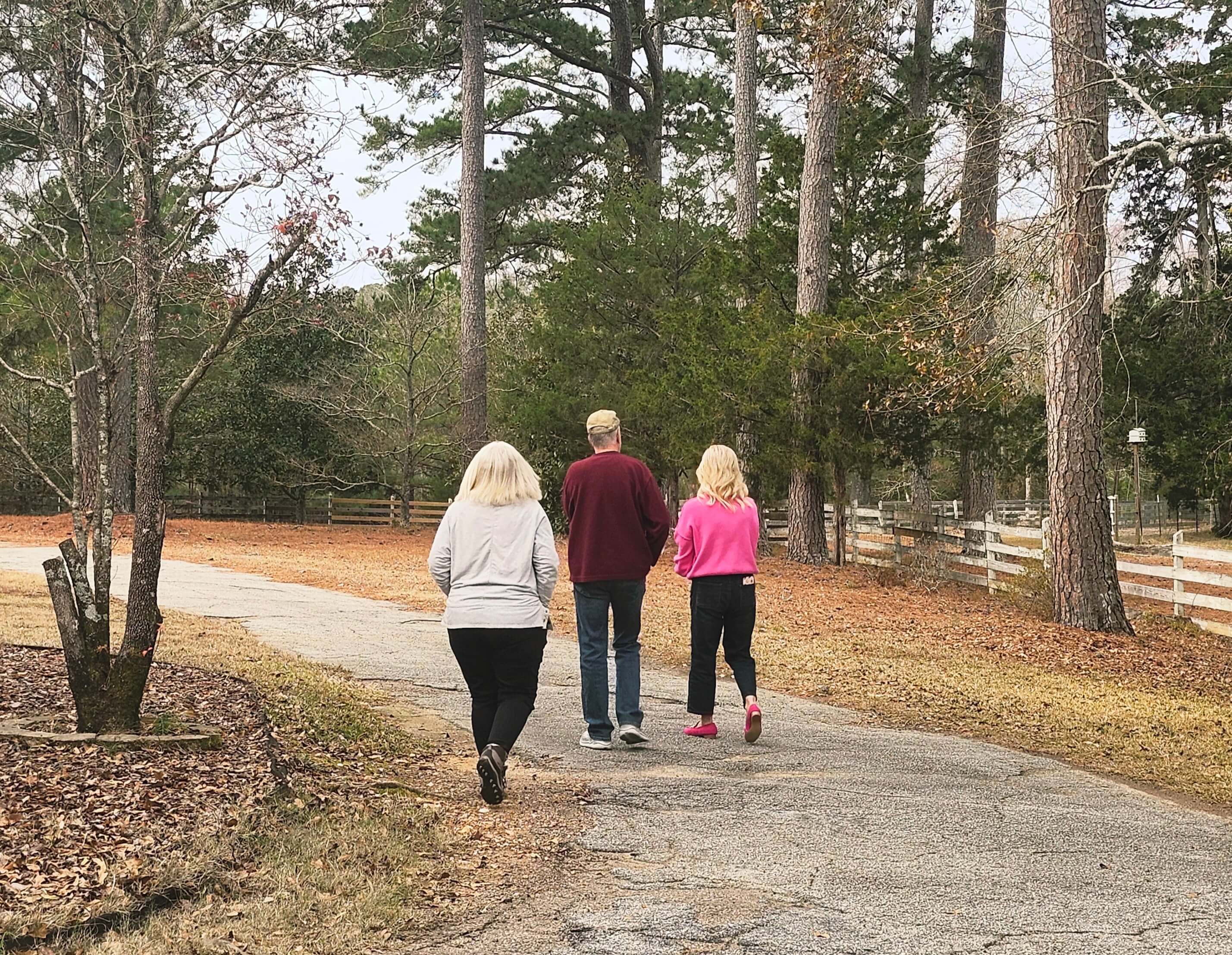 Active adults walking on a wooded drive in Savannah Lakes Village community