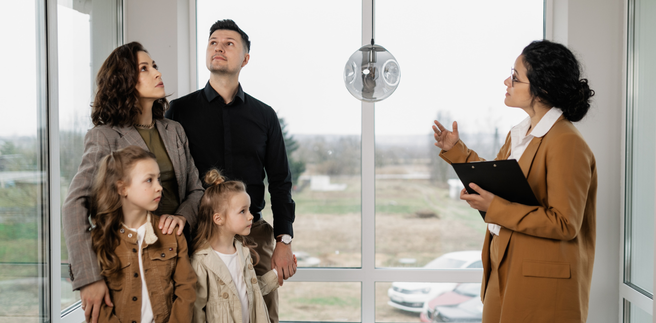 A Realtor with a Family in a House Viewing