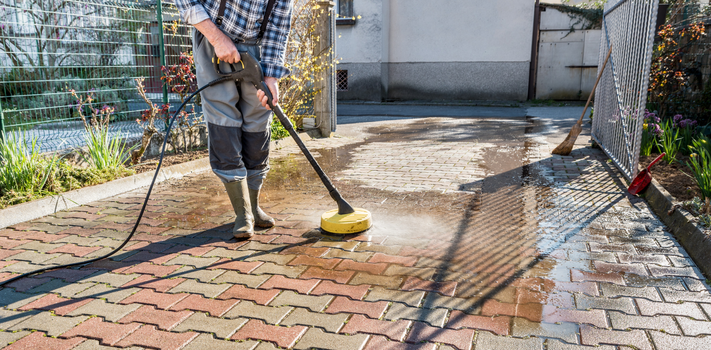 Man Deep Cleaning the House Entrance with High Pressure Washer