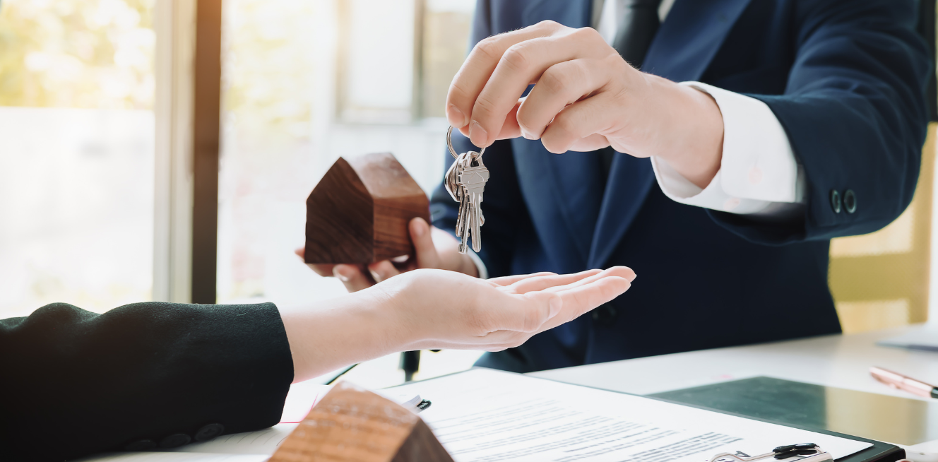 Real Estate Agent Holding House Key to His Client