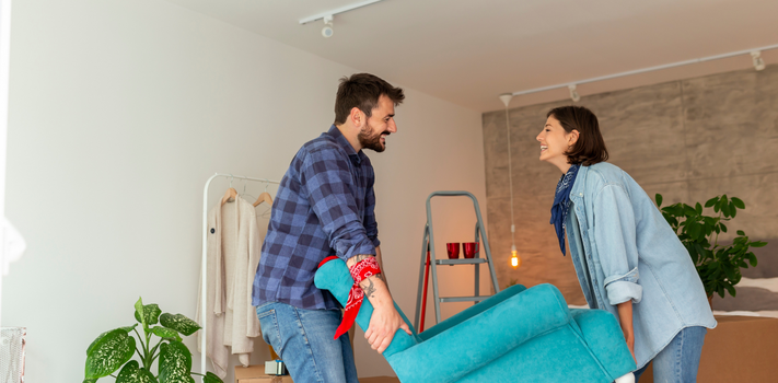 couple carrying furniture