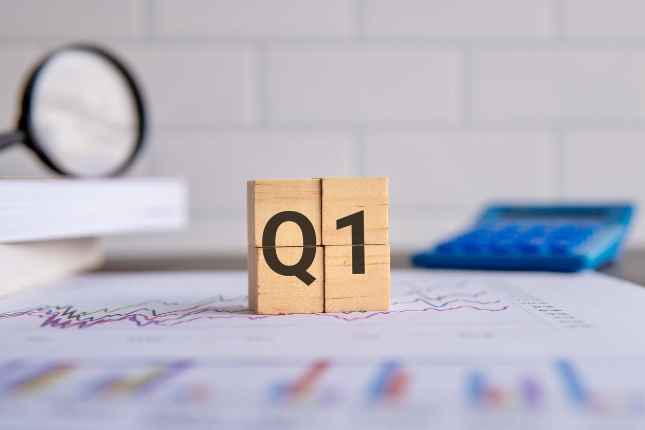 Close up image of wooden cubes with alphabet Q1 on office desk.