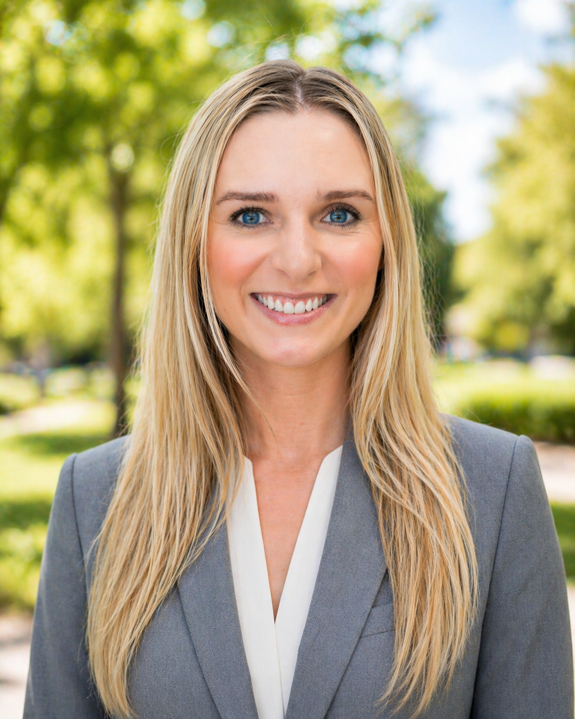 Audrianna Farris headshot in a park with a slightly blurred background