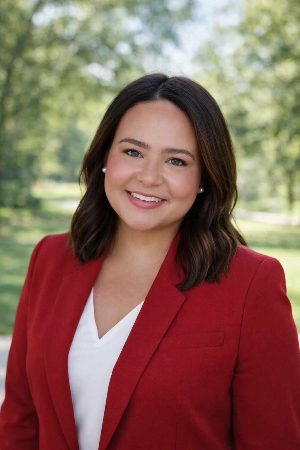 Taylor Stanford standing outside in business professional attire for a headshot photo
