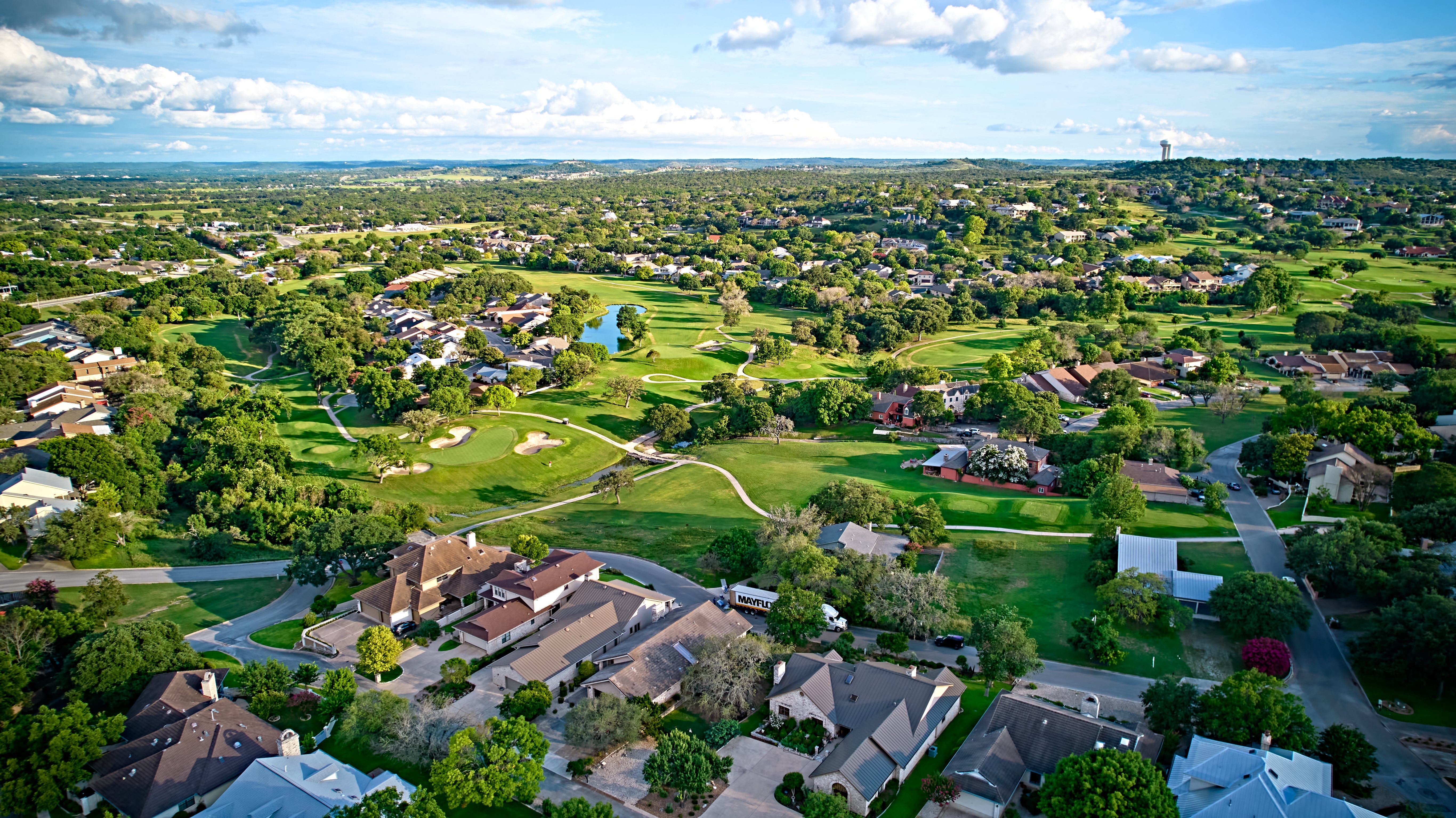 A bird’s-eye view of the surroundings of residential buildings and beautiful green fields. Houston, Texas, USA. Development of suburban housing construction. general plan