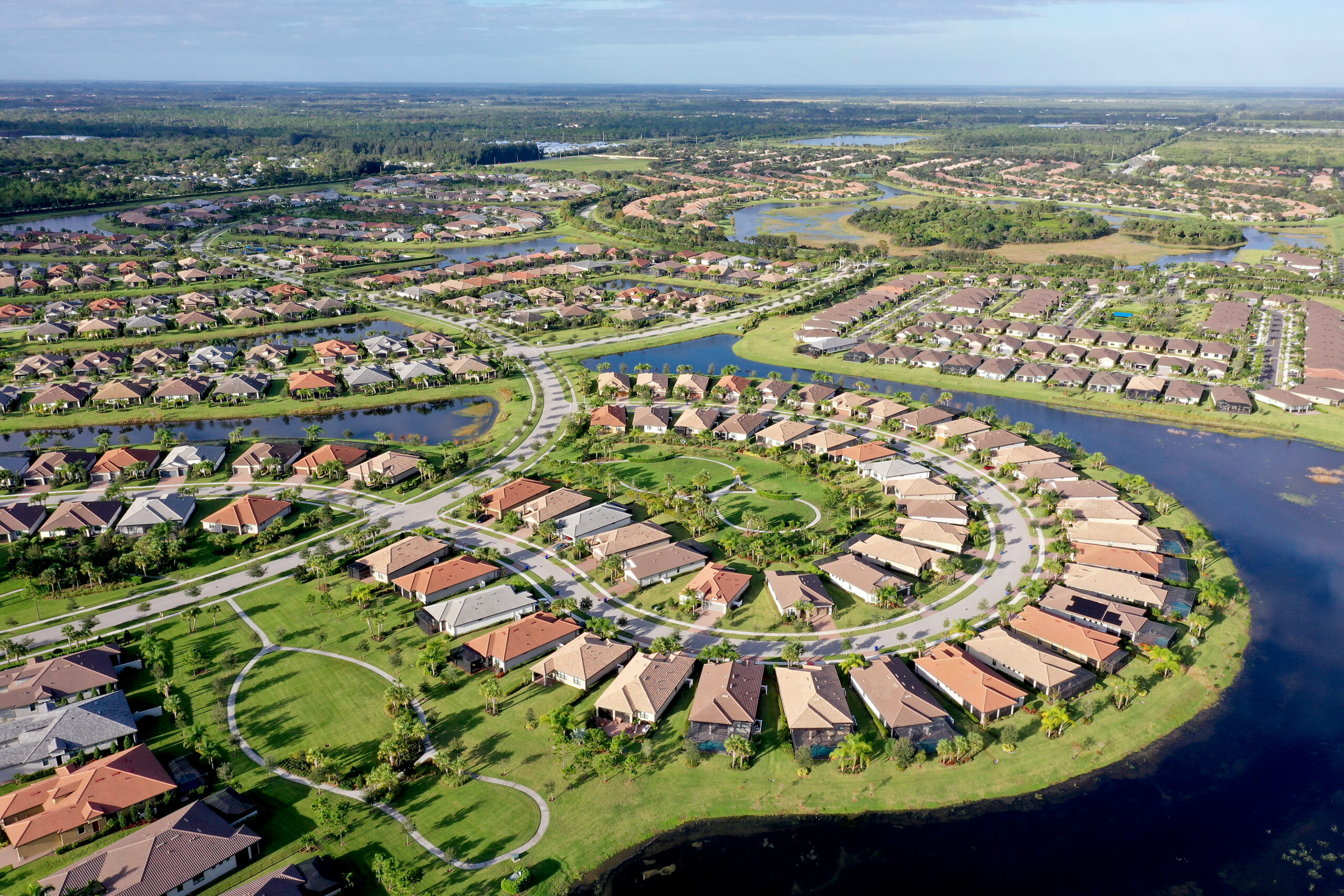 Aerial view of Waterway Village homes, lakes, and landscaped community amenities in Vero Beach