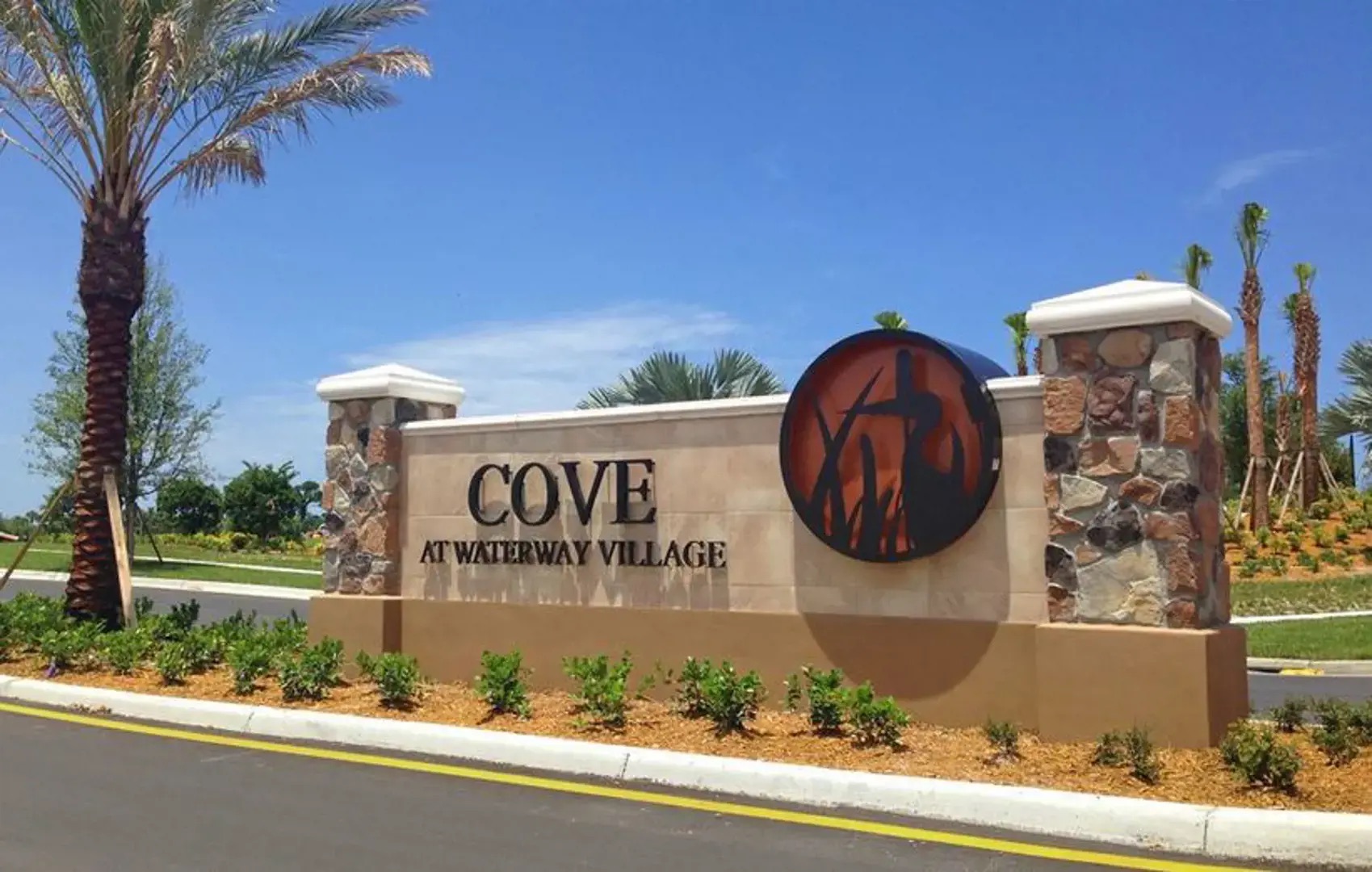 Landscaped entrance to The Cove at Waterway Village