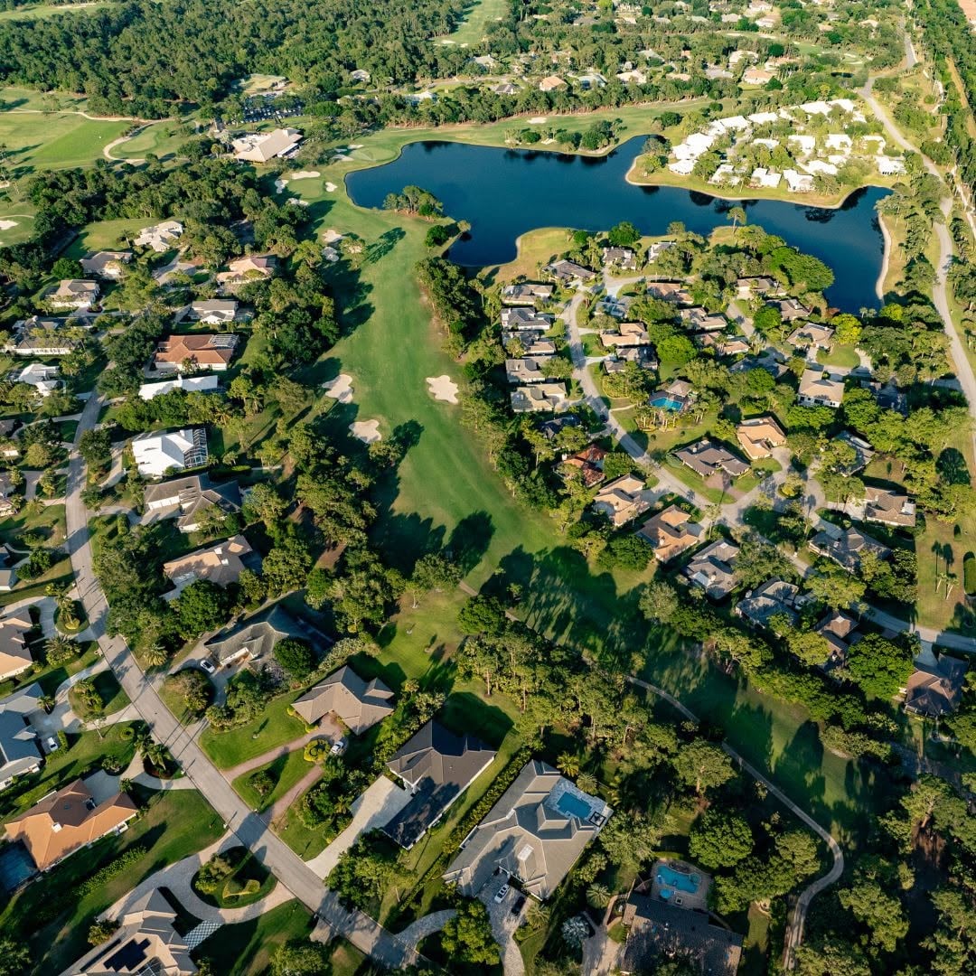 Aerial view of homes, fairways, and lakes within Bent Pine Golf Club