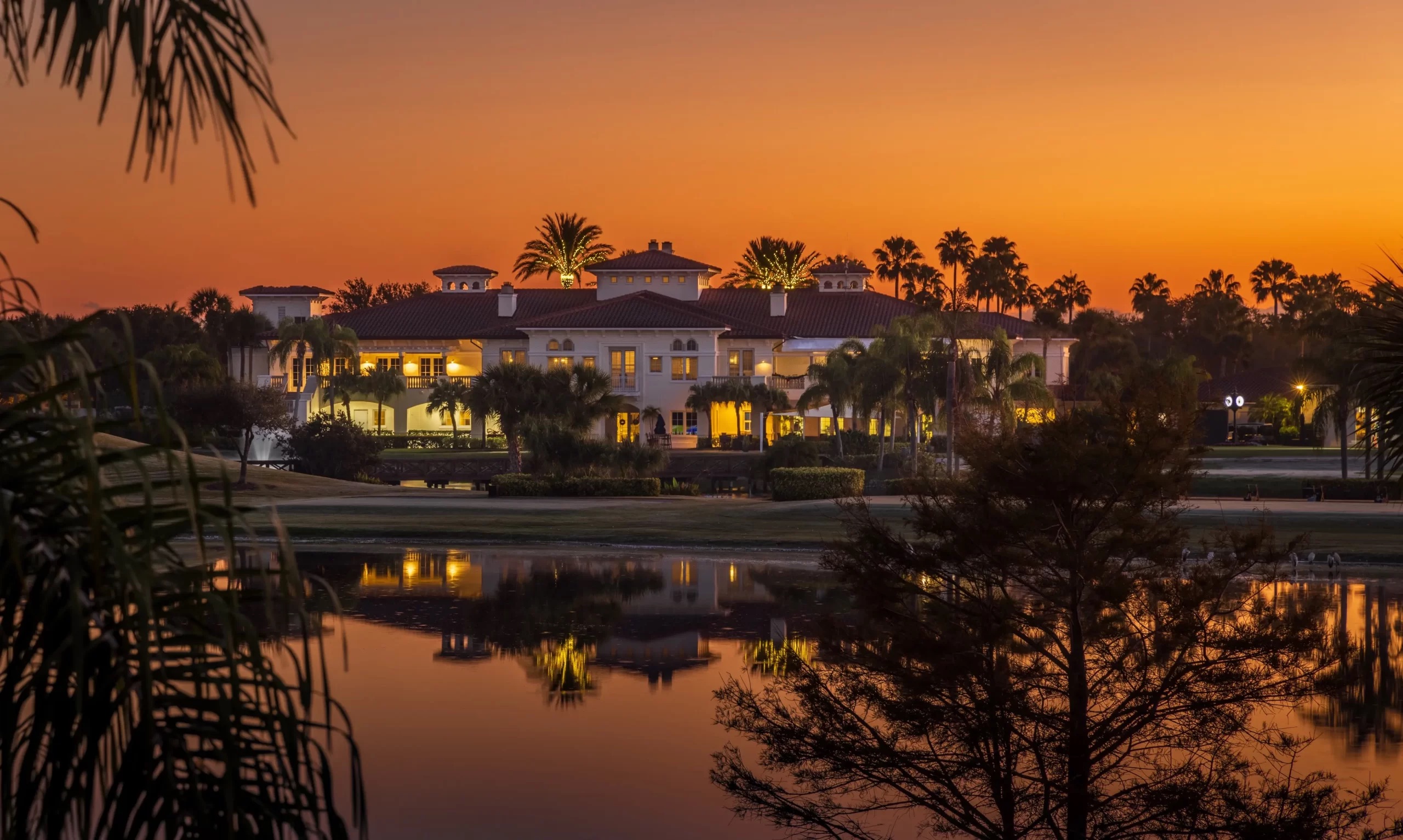 Grand Harbor clubhouse illuminated at sunset