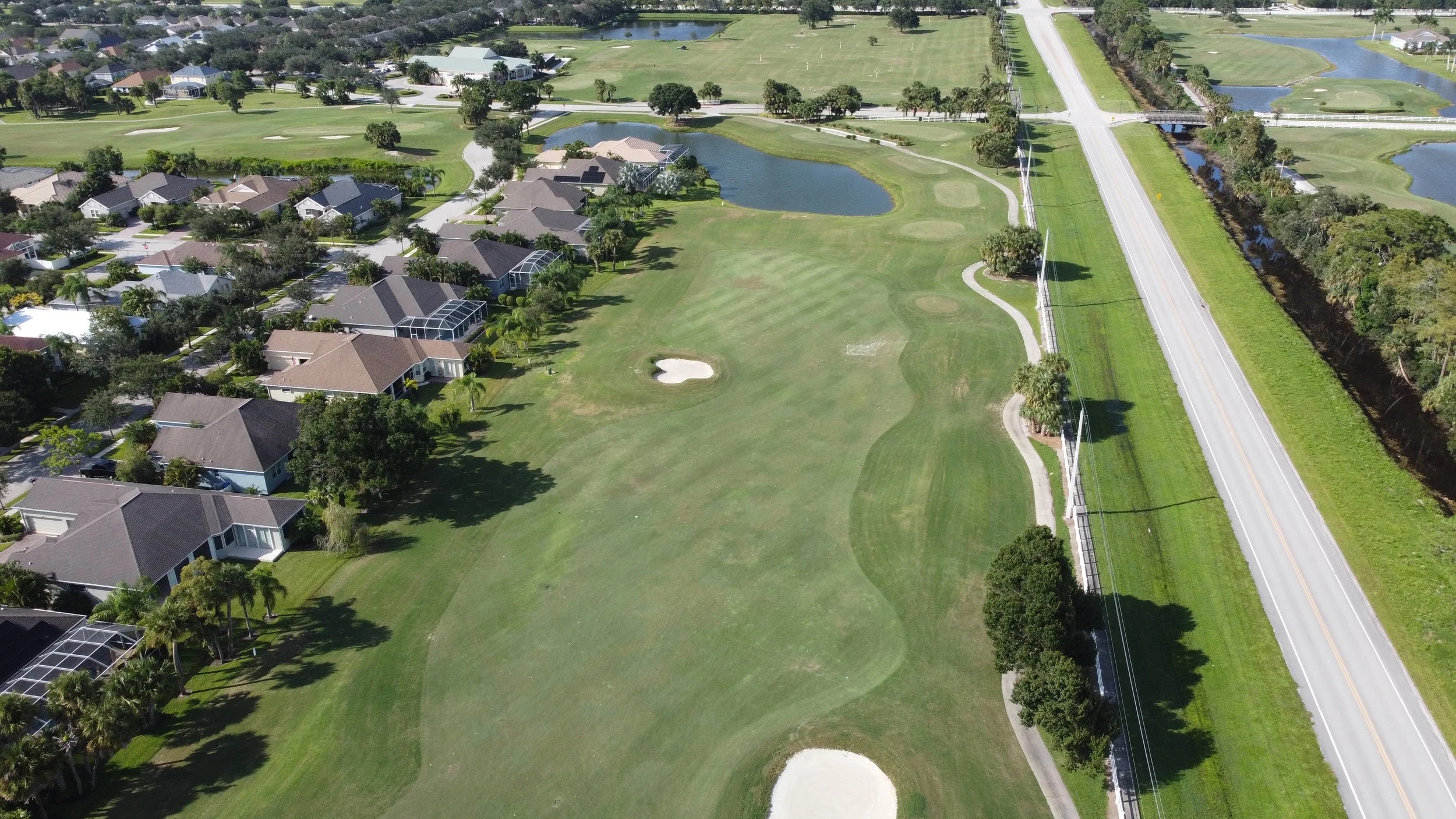 Aerial view of the Pointe West golf course, lakes, and surrounding residential community in Vero Beach