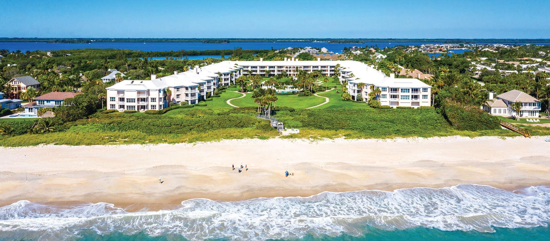 Aerial view of waterfront homes and waterways within The Moorings in Vero Beach