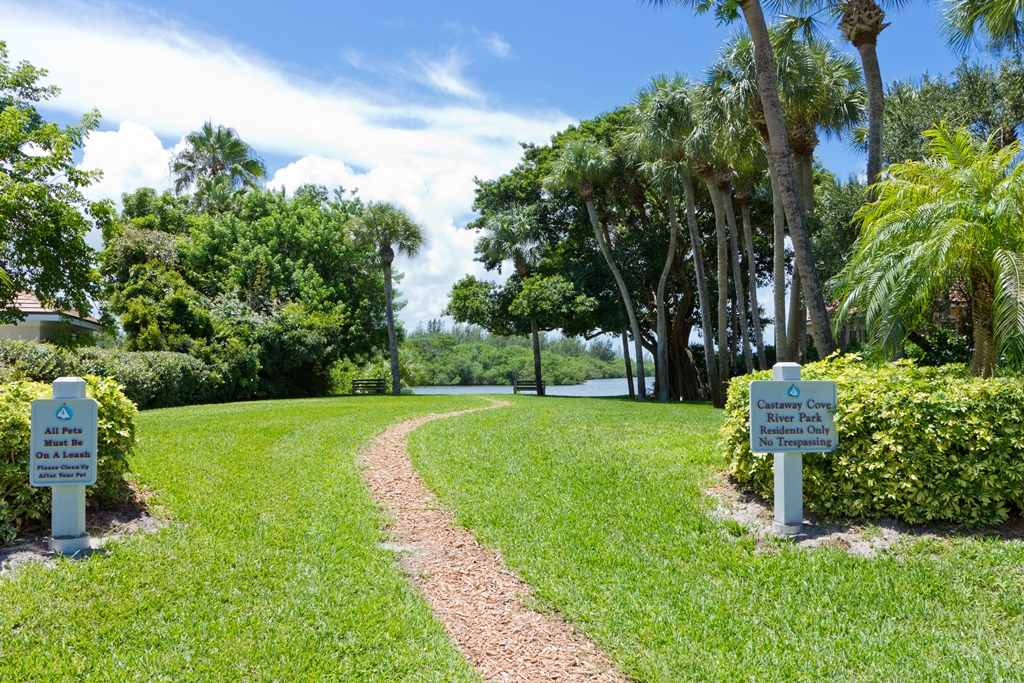 Waterfront lawn and riverfront setting within Castaway Cove
