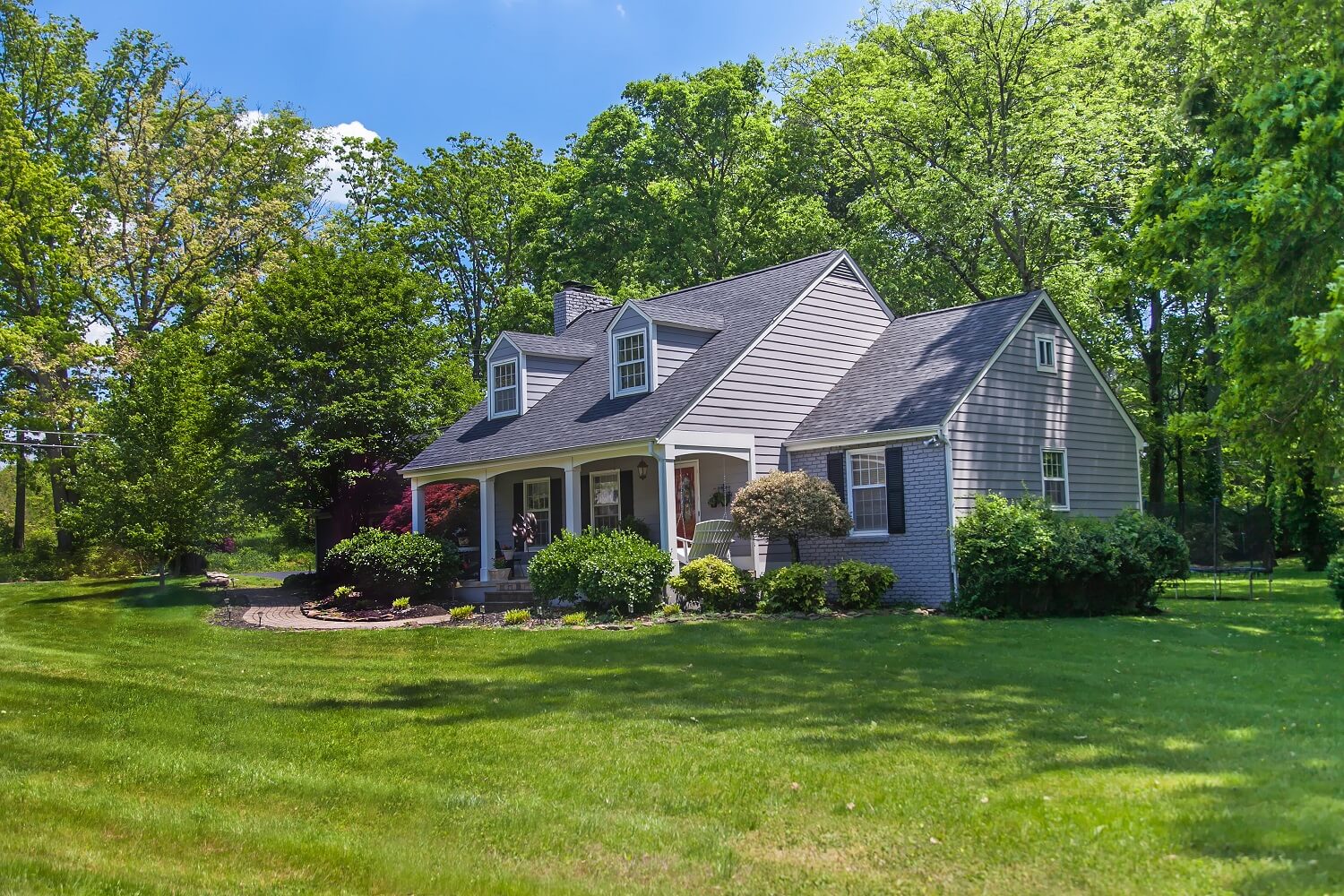 Panoramic view of beautiful house and garden
