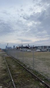 Active demolition underway at the Oracle Nashville River North campus site on the East Bank with the Nashville skyline visible in the background