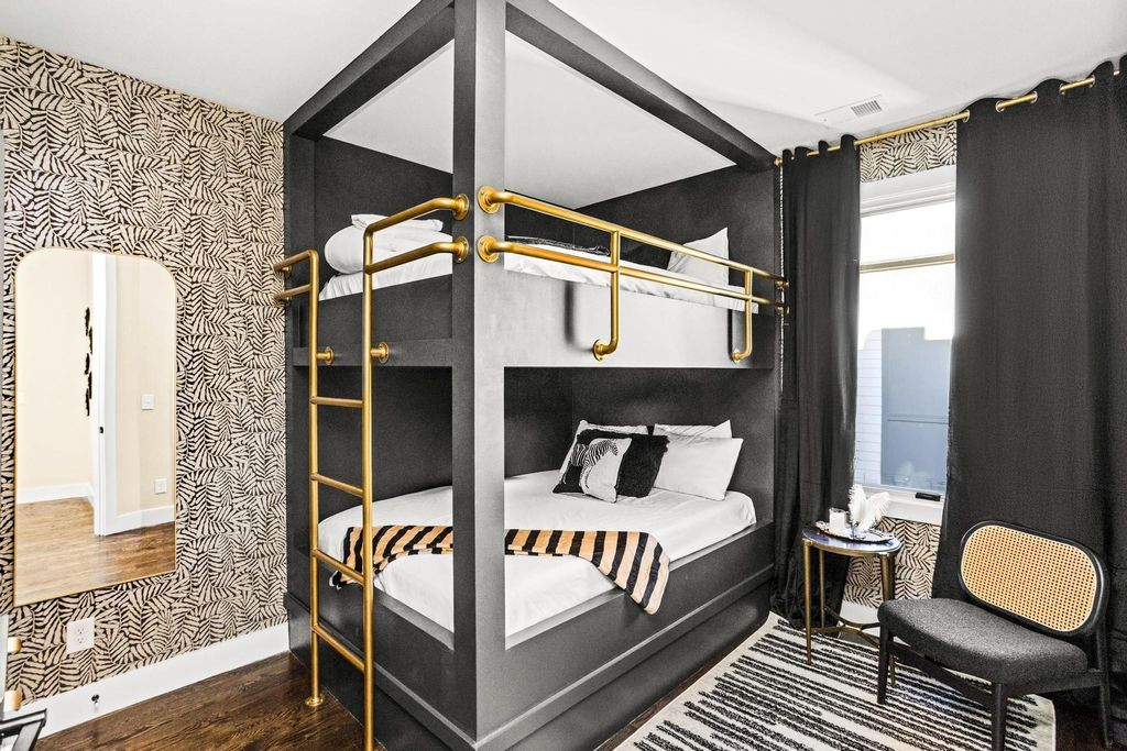 Designer bunk room interior at Alora Nashville short-term rental property with custom millwork and gold accent fixtures